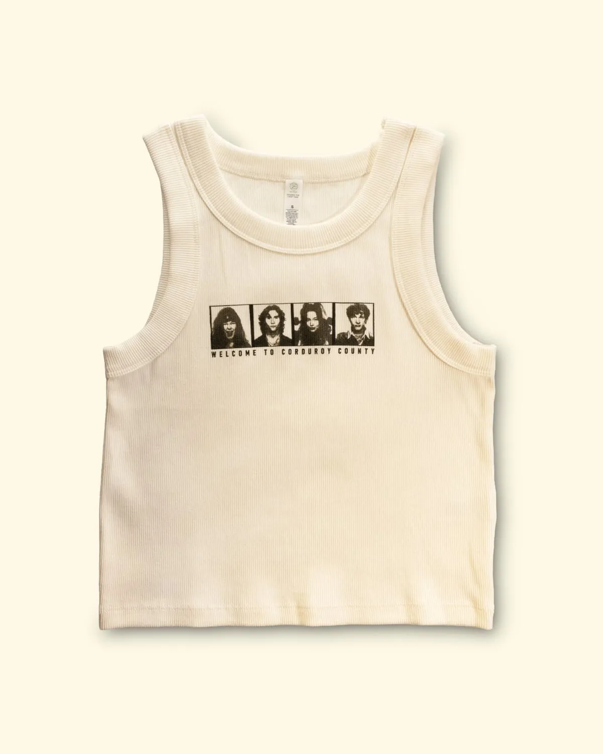 Ribbed cream crop tank printed with four portrait frames above the words “Welcome to Corduroy County”.